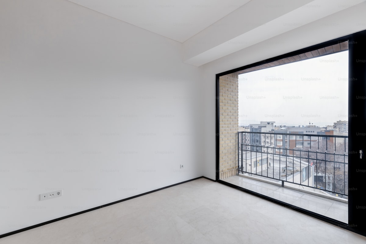 Empty open concept room with glass doors